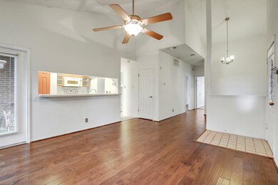Unfurnished living room with high vaulted ceiling