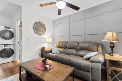 Living area with stacked washer and dryer, wood fi