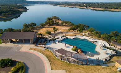 Aerial view of a pool area and a large body of wa