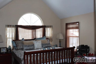 Vaulted ceiling with ceiling fan.