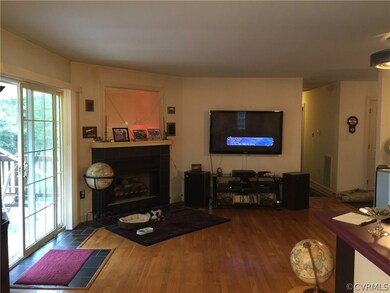 Gas Log Fireplace and Built In Entertainment Shelf above FP. Sliding Glass Doors to Deck.