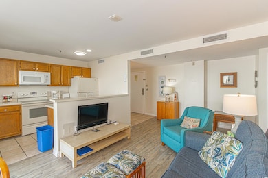 Living area featuring visible vents and light wood-type flooring
