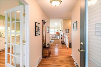 Gleaming hardwood floors greet you.