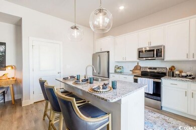 Kitchen featuring light stone countertops, a kitch