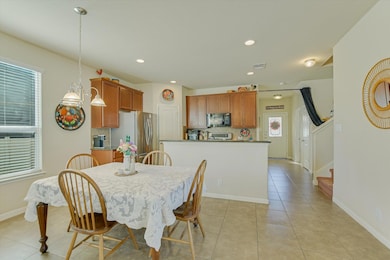 Dining area featuring stairs, light tile patterne