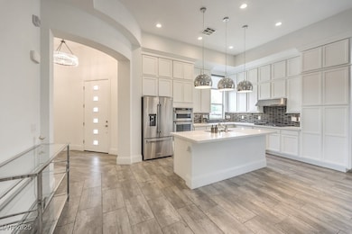 Kitchen featuring under cabinet range hood, visibl