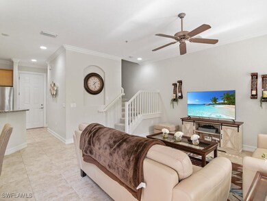 Living room featuring crown molding, ceiling fan,