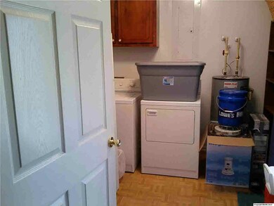 Huge laundry room. Opens to kitchen and carport.