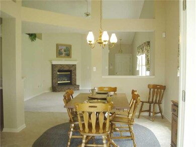 Great Room. This Great Room is large, has a gas log fireplace and note the cut out divider separating the dining area.  This view is from the 4 season sun room.