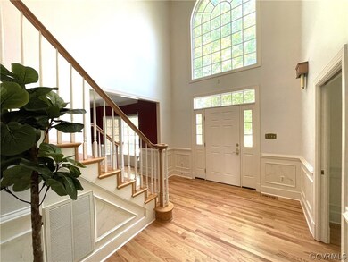 Entryway with light wood-type flooring and a high