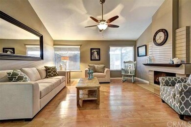 Living Room offers Laminate wood floor, Ceiling fa