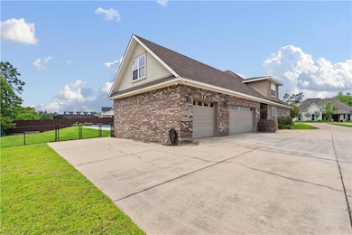 View of home's exterior featuring fence, an attach