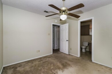 Unfurnished bedroom with carpet flooring, a textu