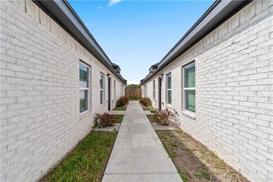 View of home's exterior with brick siding and fence