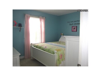 Bedroom has newer windows, window treatments and 2
