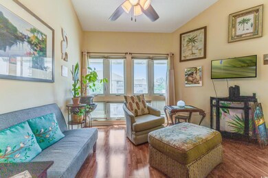 Living area with wood finished floors and a ceiling fan