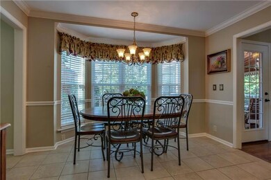 Breakfast nook overlooking the pergola covered patio.  The kitchen measures 21x12 in total.   Seating for 3 at the breakfast bar too!