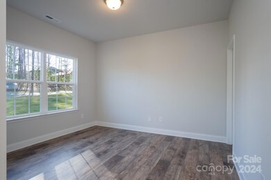 Living Room with Walk In Closet. Photo representation. Colors and options will differ.