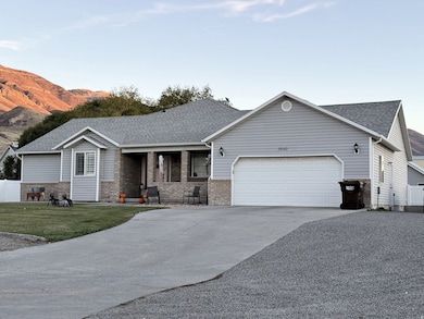 Ranch-style home with covered porch, driveway, roof with shingles, and brick siding
