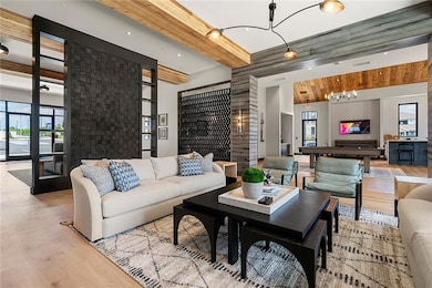 Living room featuring beam ceiling, plenty of natu