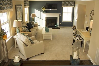 Family room is off the kitchen - open floor plan.  Photo shown is not actual home for sale which does not have a fireplace