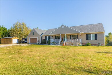 Single story home featuring a garage, a storage sh