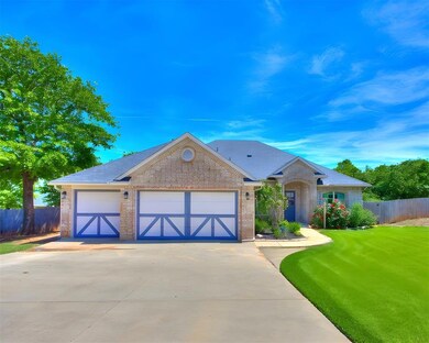 Single story home with driveway, brick siding, an 