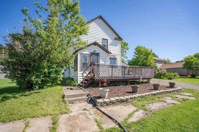 View of front facade with a wooden deck and a fron