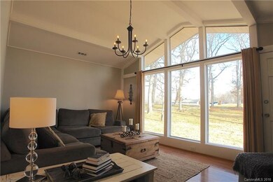 Living Room with Vaulted Ceilings and Floor to Cei