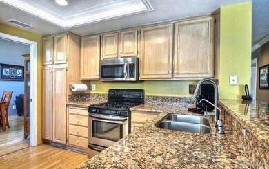 The immaculate kitchen  exhibits glossy granite co