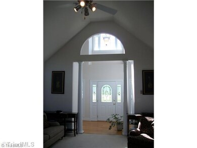 Entry. Custom features include columns, hardwoods, tile, solid surface countertops, double trey ceiling, trim.