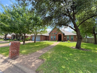 Ranch-style home featuring an attached garage, dri