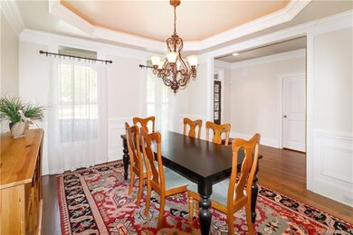 FORMAL DINING ACCENTED BY TRAY CEILING & CHANDELIE