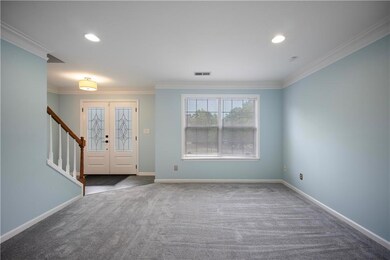 Unfurnished living room with light colored carpet,