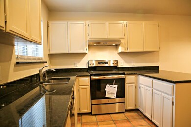 Kitchen with stainless steel electric stove, unde