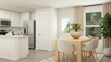 Kitchen featuring white cabinets, stainless steel 