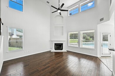 Unfurnished living room featuring a towering ceil