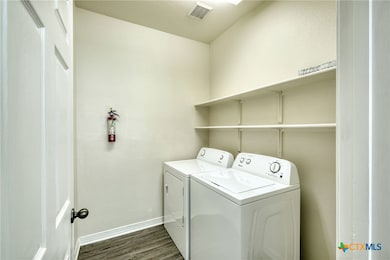 Laundry room with washer, dryer, and plenty of storage space