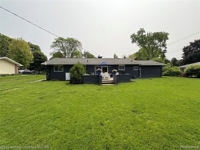 Back of house featuring a yard, an outdoor living space, and a deck