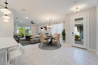 Tiled dining area featuring ceiling fan with notab