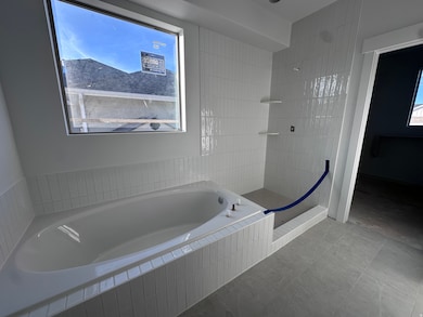 Full bathroom with a bath, walk in shower, and tile patterned flooring