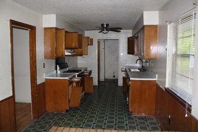 Kitchen with a sink, dark floors, brown cabinetry,