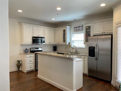 Kitchen features subway tile, stainless steel appl