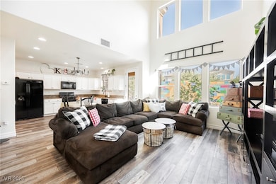 Living area with light wood-style flooring and baseboards