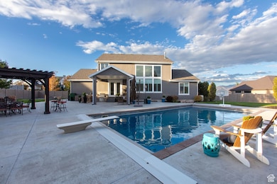 View of pool featuring a patio, french doors, a pergola, and a diving board