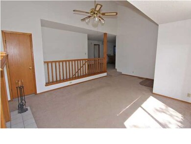 WOOD RAILING SEPARATED LIVING AND DINING ROOM