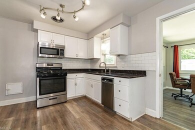 Kitchen with Granite counters and Luxury vinyl flo