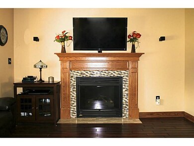 Living Room Gas fireplace with oak mantel and glas