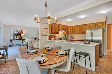 Breakfast Area; Room features decorative parquet wood flooring, fresh new paint, three windows for natural light and a fantastic view of the backyard and deck and decorative crown molding. You also have the snack bar with room for stools The kitchen area is located on the right side and the living room is to the far end.