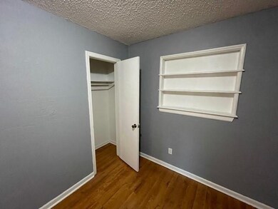 Front Bedroom showing built-in shelves & closet